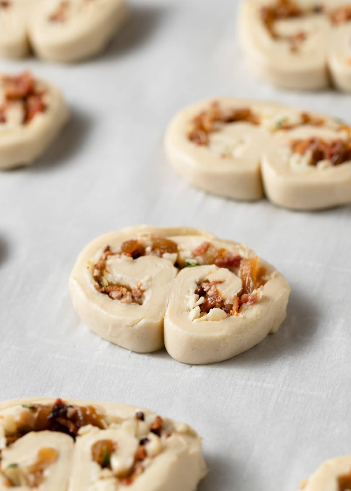 unbaked bacon palmiers on a parchment-lined baking sheet