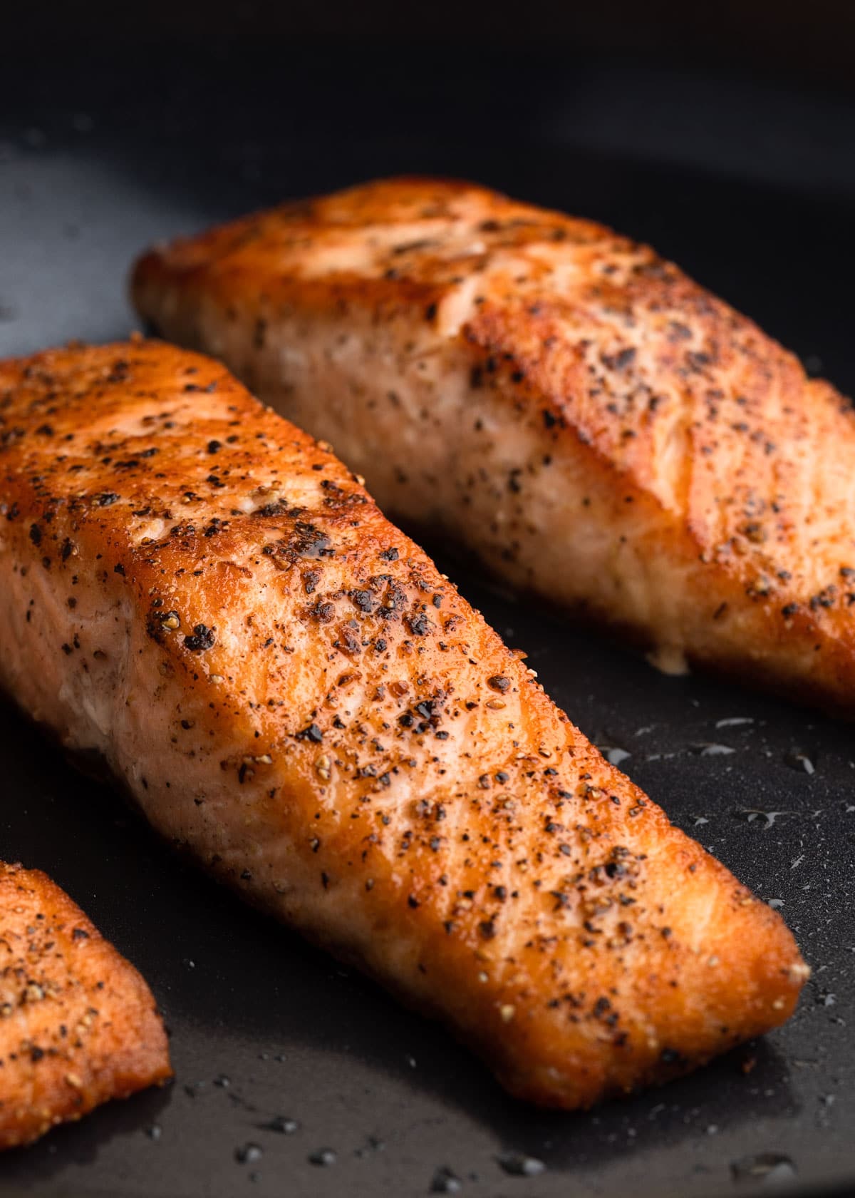 pan seared salmon fillets in a nonstick pan