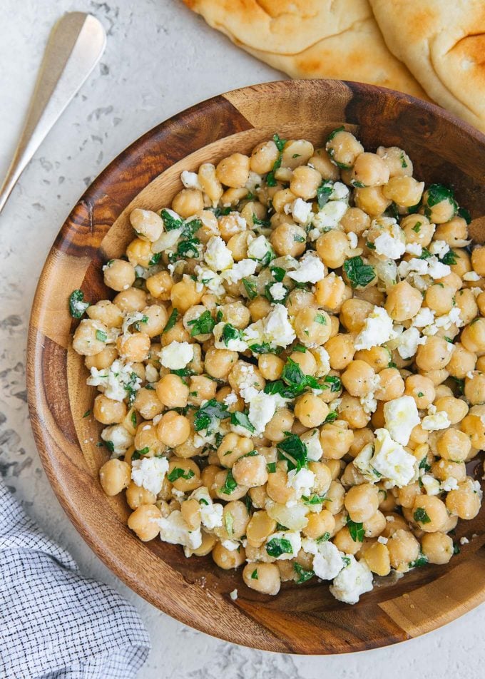 chickpea salad recipe with feta and lemon vinaigrette in a wood bowl