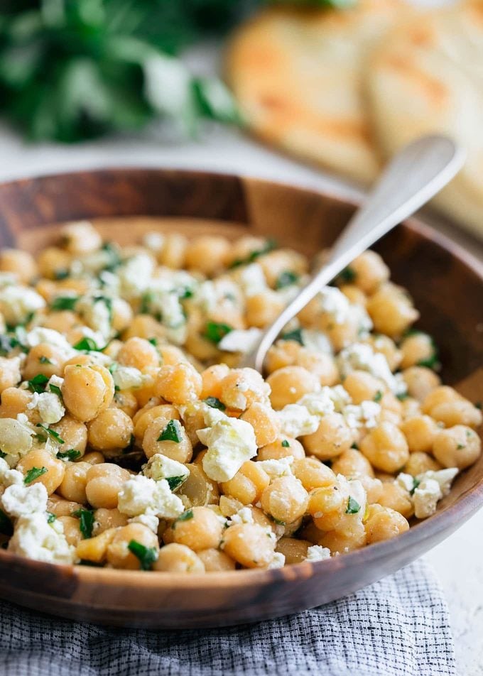 chickpea salad with feta in a wooden bowl with a spoon