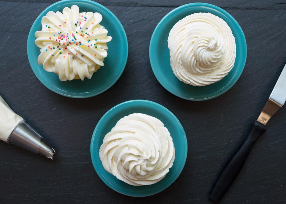 overhead of 3 cupcakes with 3 different types of vanilla frosting