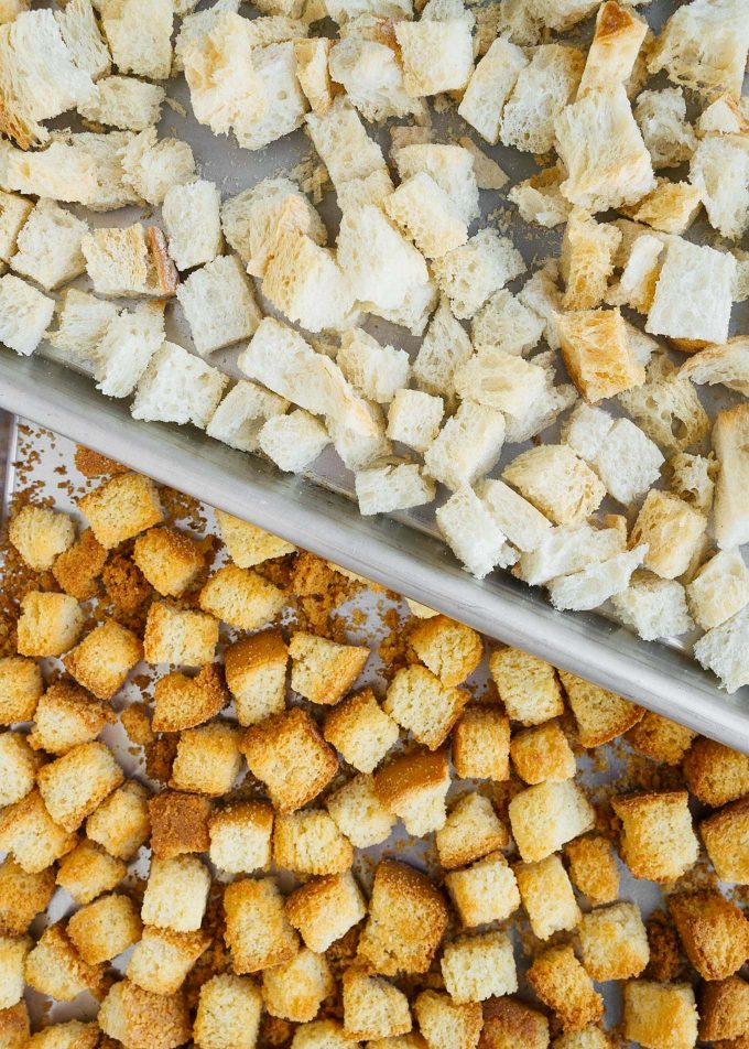 cornbread and white bread cubes on baking sheets