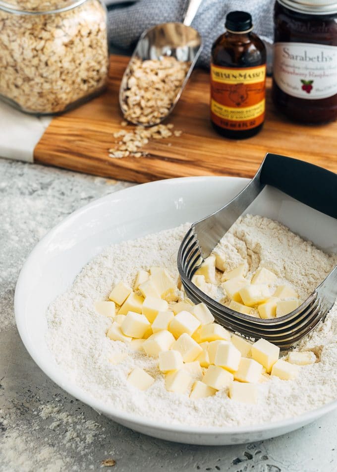 cubes of butter with flour and a pastry blender in a bowl