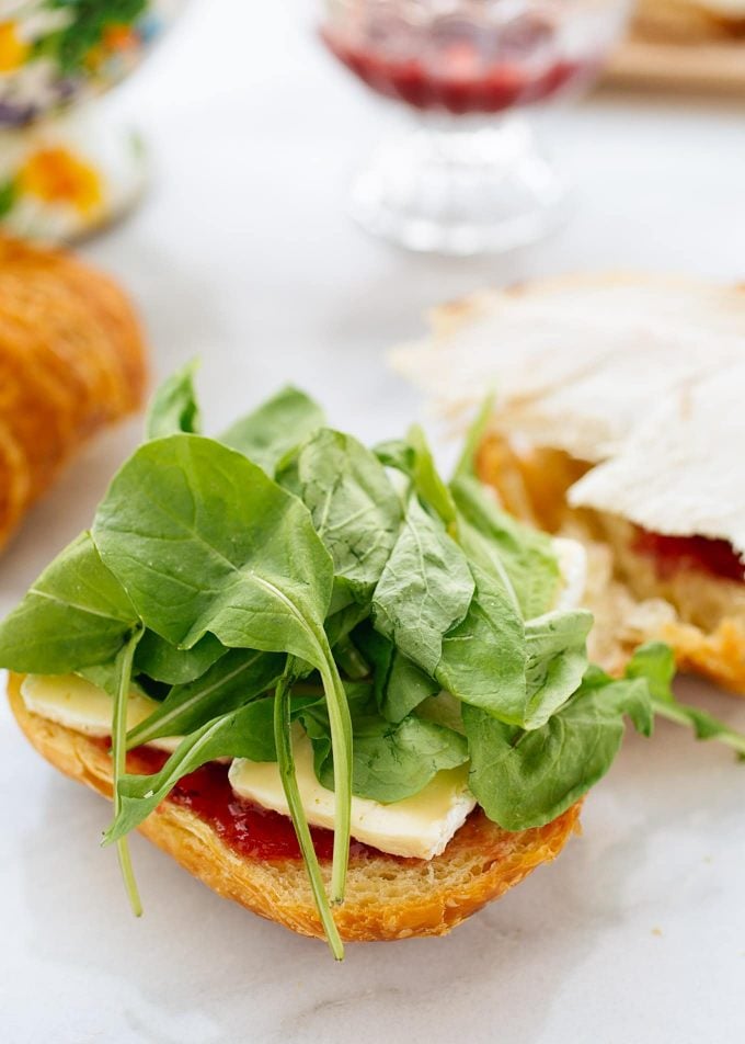 closeup of baby arugula leaves on a turkey croissant panini