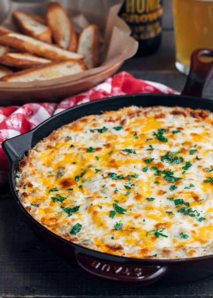 baked crab and artichoke dip in a cast iron skillet