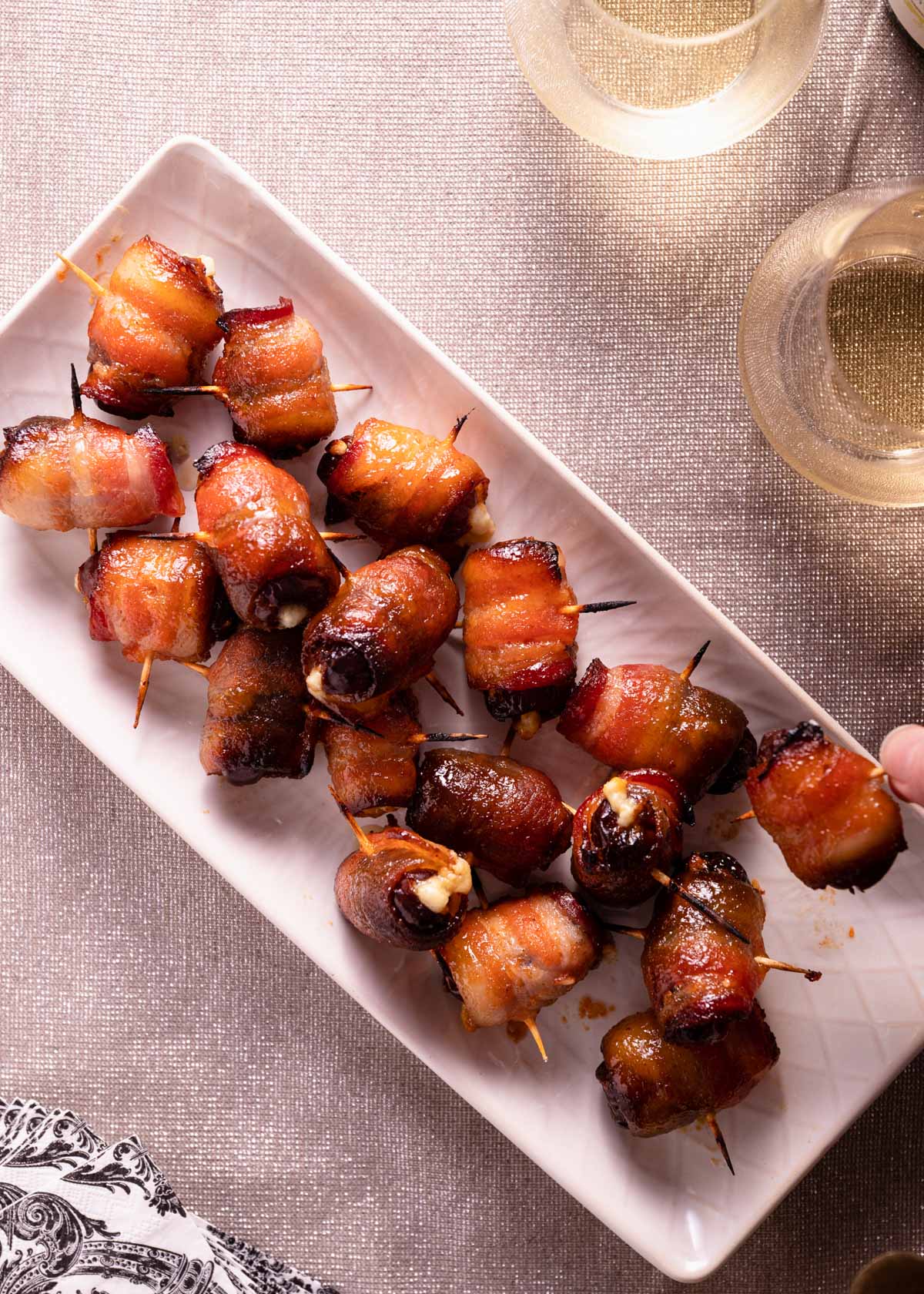 overhead photo of a platter of bacon wrapped stuffed dates