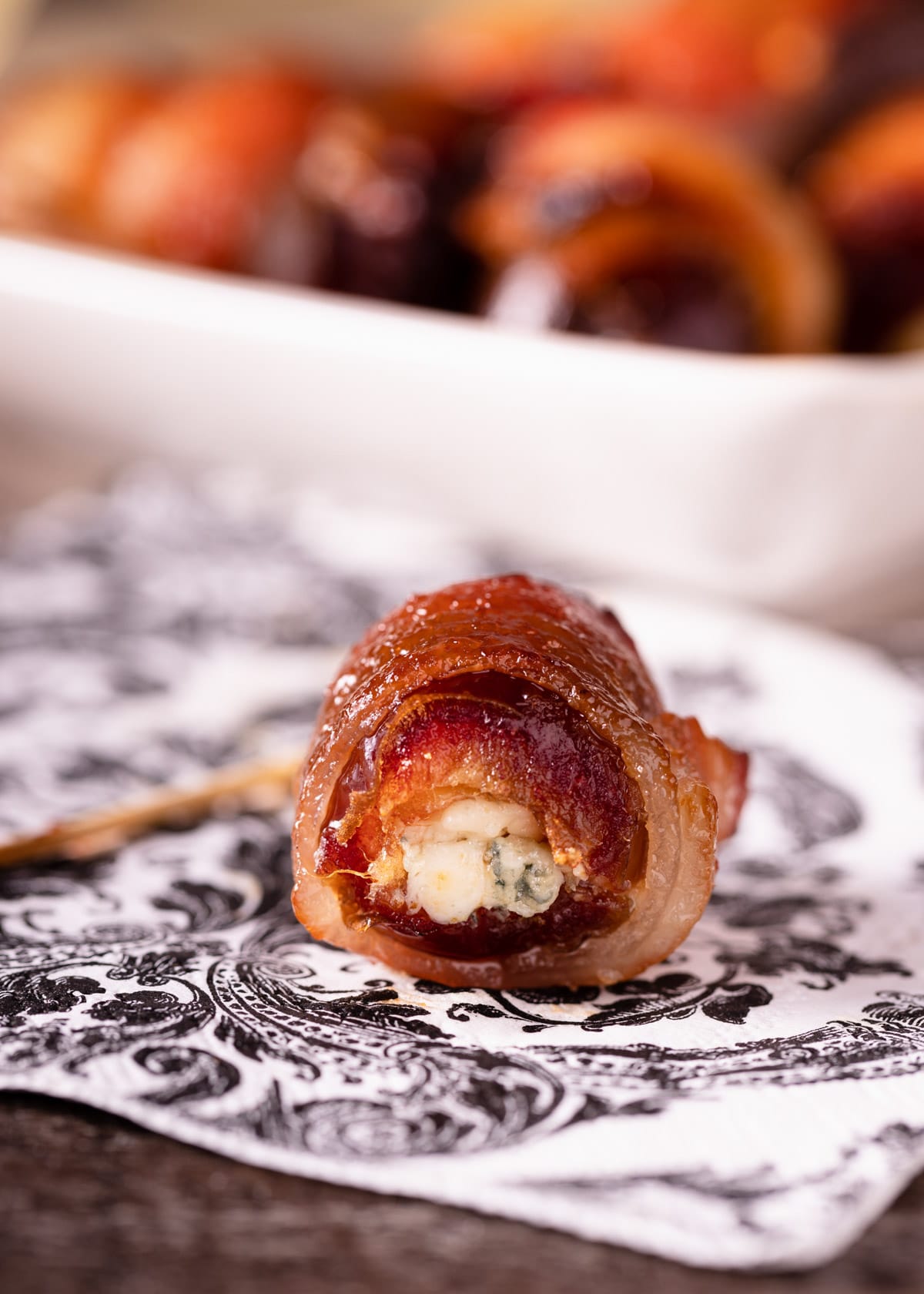 closeup of a blue cheese stuffed date on a printed napkin