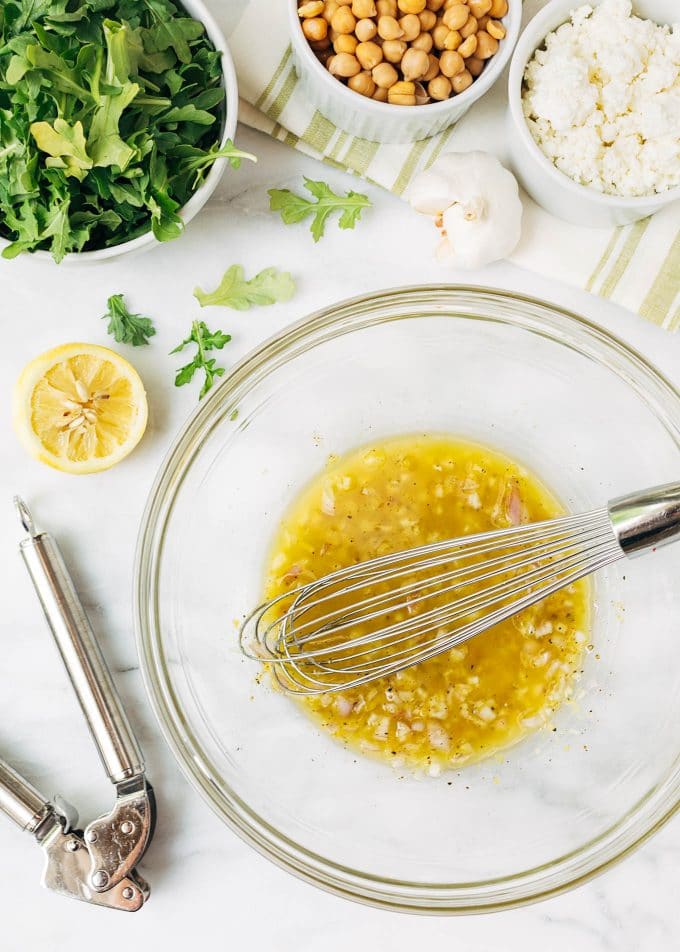 lemon shallot vinaigrette in a glass bowl with a whisk