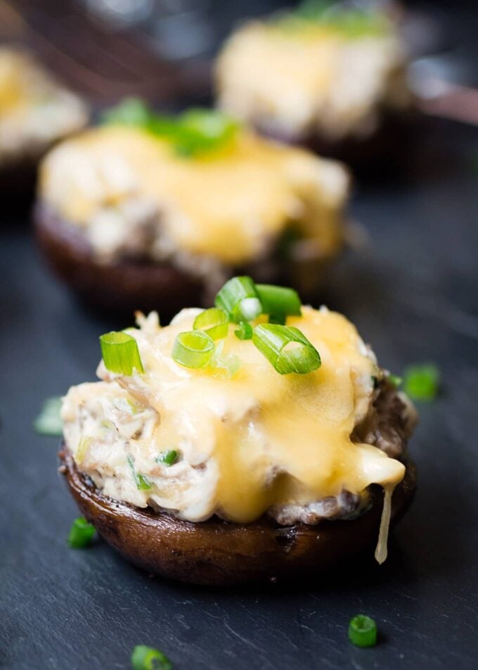 Crab Stuffed Mushrooms with Gouda Cheese on a slate board