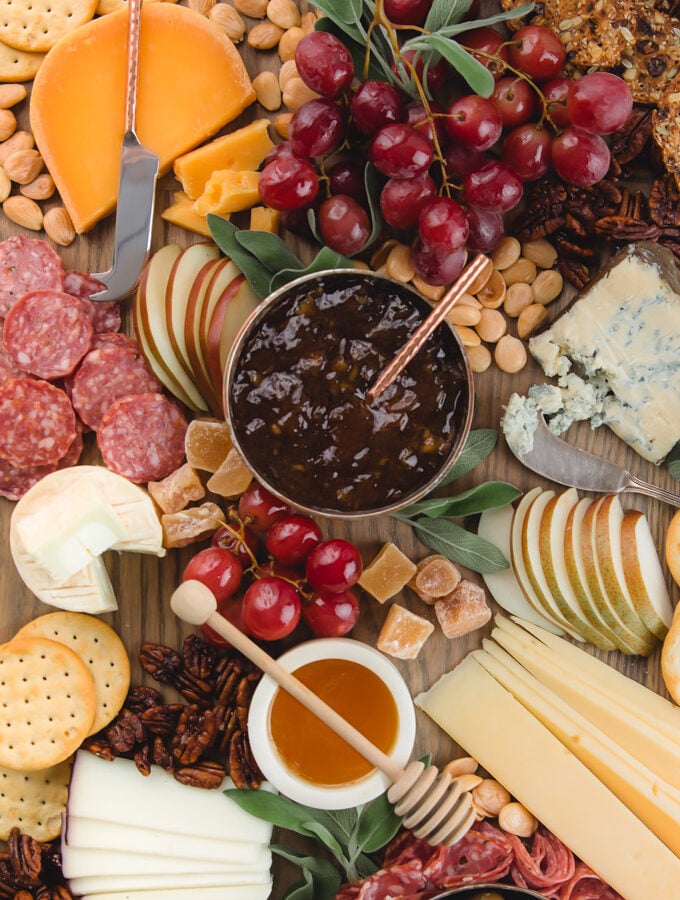 closeup view of a cheese board with fresh fruit and charcuterie