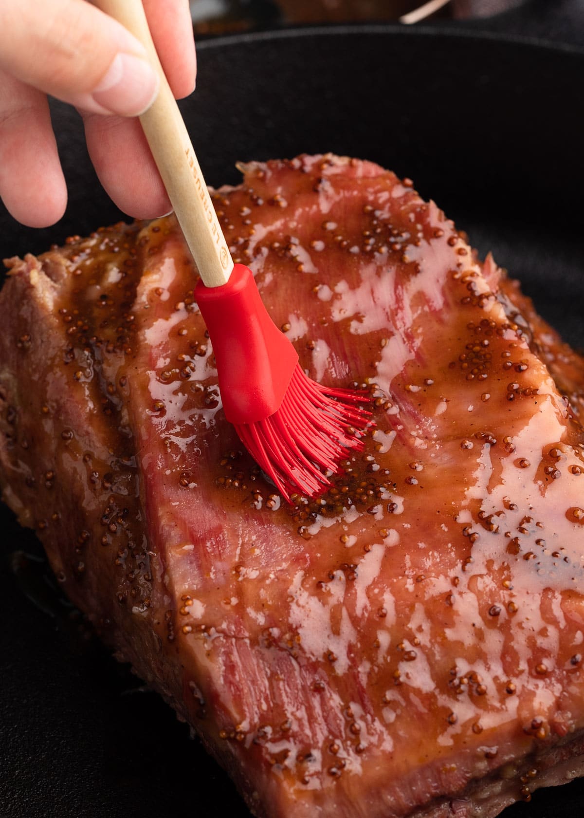 brushing braised corned beef with whiskey mustard glaze