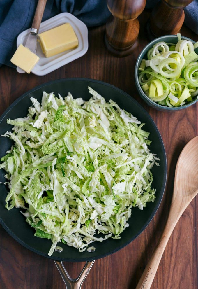 shredded savoy cabbage in a sauté pan for colcannon