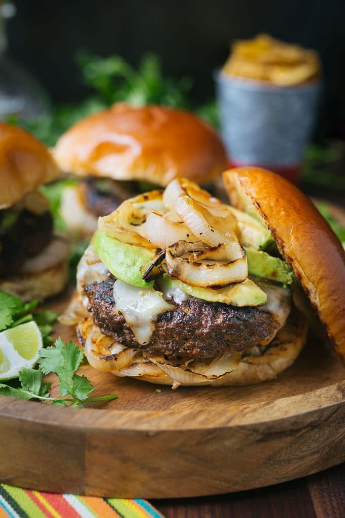 Cuban mojo beef burgers with grilled onions and avocado