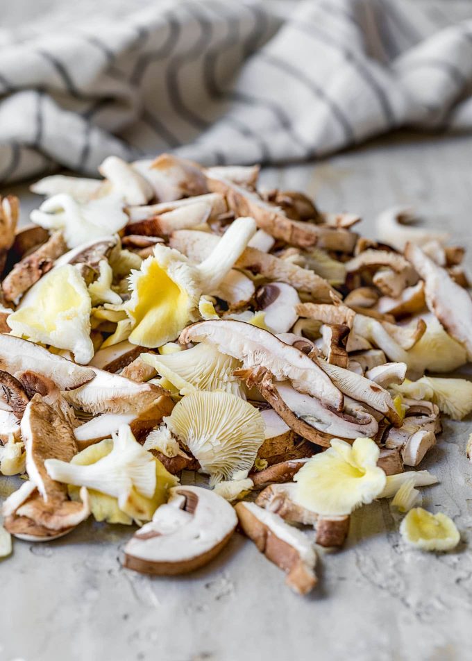 sliced assorted gourmet mushrooms with a striped napikin