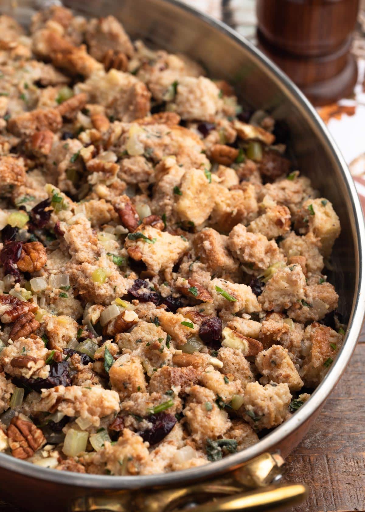 assembled cranberry stuffing in a tin-lined copper gratin pan before baking