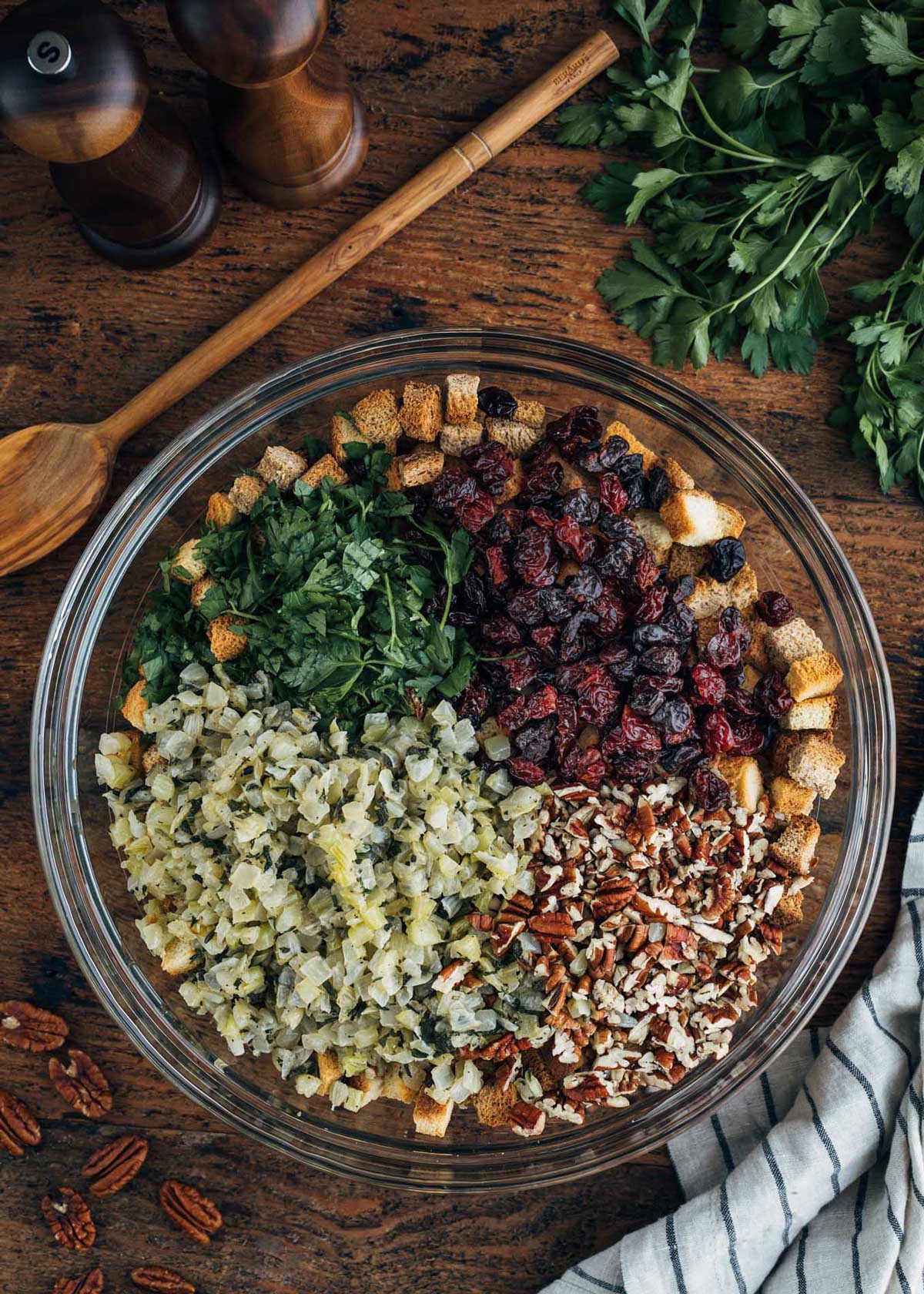 dried cranberries, pecans, croutons, and sauteed onions and celery in a large glass bowl