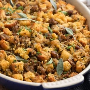 sausage and chestnut stuffing in a gratin dish garnished with parsley and sage leaves