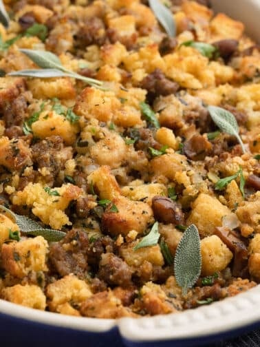 sausage and chestnut stuffing in a gratin dish garnished with parsley and sage leaves