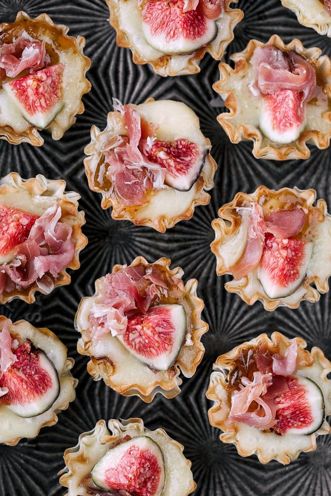 miniature phyllo cups with brie and figs on a serving tray