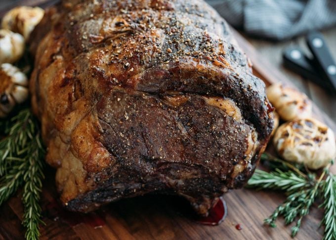 whole slow roasted prime rib on a walnut carving board