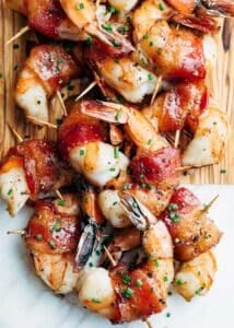 bourbon glazed bacon wrapped shrimp on a serving board