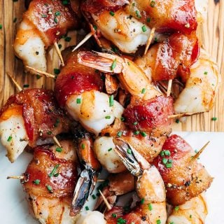 bourbon glazed bacon wrapped shrimp on a serving board