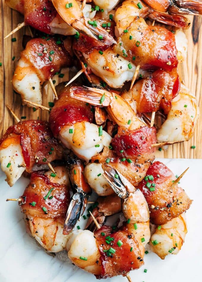 bourbon glazed bacon-wrapped shrimp on a serving board