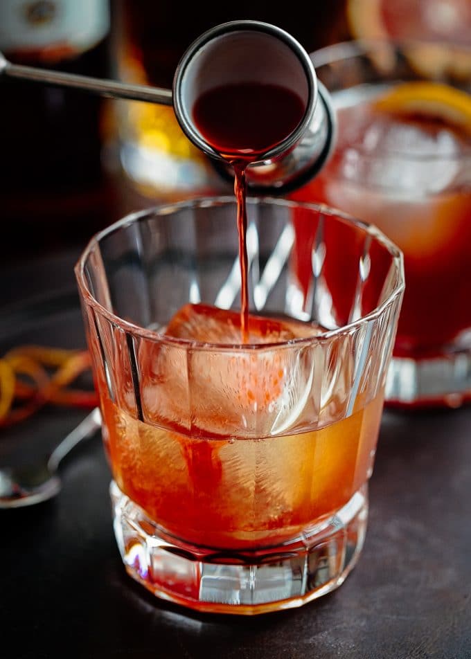 pouring campari for blood orange boulevardier recipe