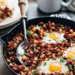 corned beef hash and eggs in a cast iron skillet