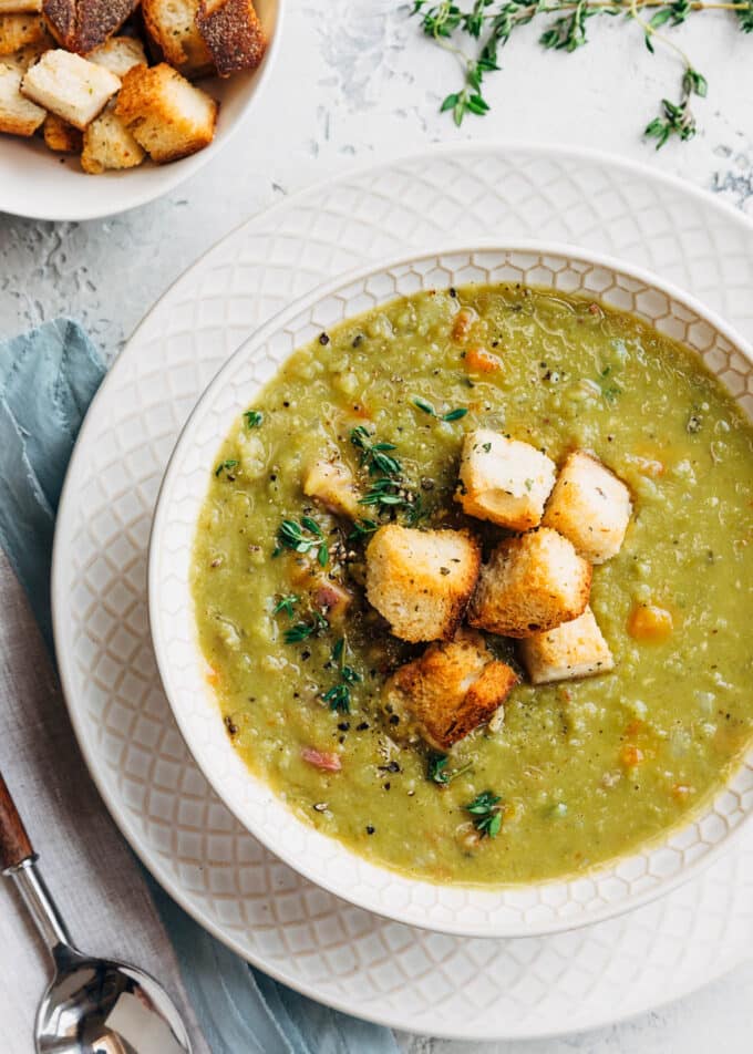 split pea soup with ham and croutons in an ivory porcelain bowl