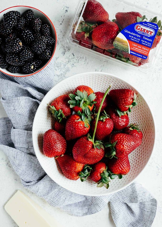 bowls of strawberries and blackberries and a California Giant Berry Farms strawberry carton {sponsored}