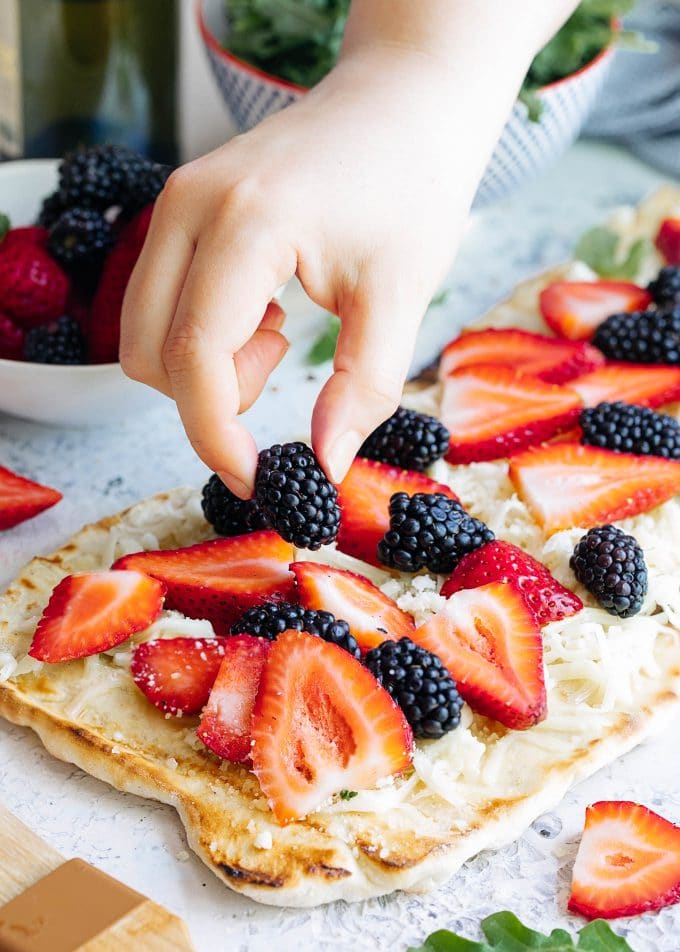 placing summer berries onto grilled flatbread {sponsored}