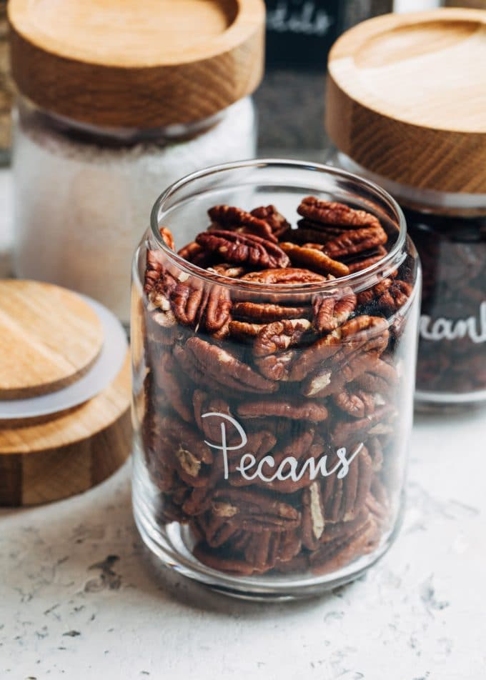 pecans in wood-topped glass jars