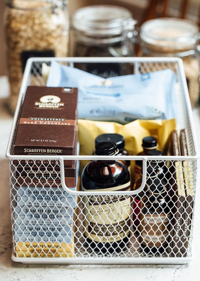 wire baskets with baking supplies for pantry organization