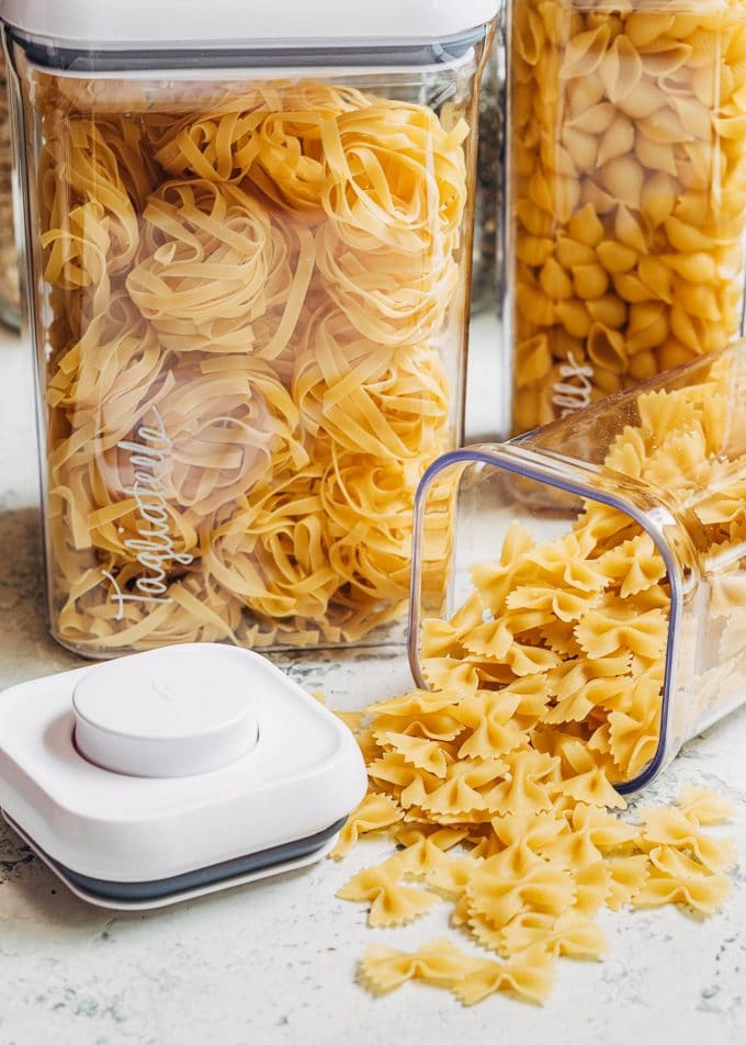 dried pasta in OXO pop top plastic canisters