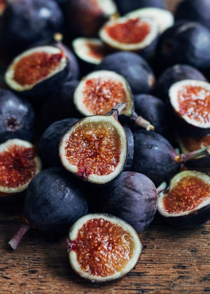 whole and halved figs on a wood board