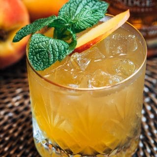 bourbon peach smash cocktail with mint