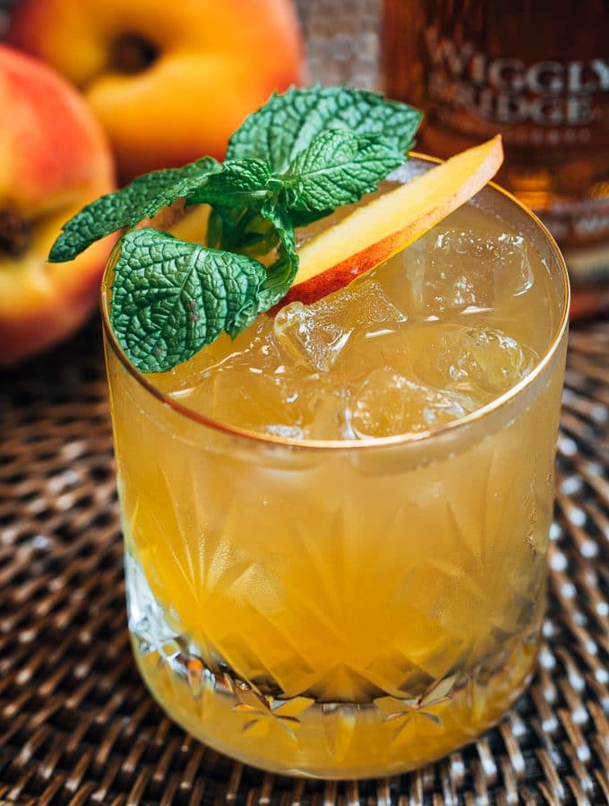 bourbon peach smash cocktail with mint