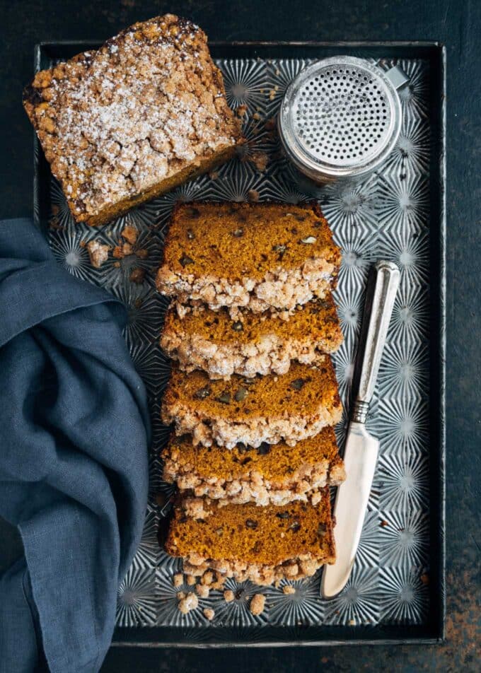 slices of streusel topped pumpkin bread on a baking sheet