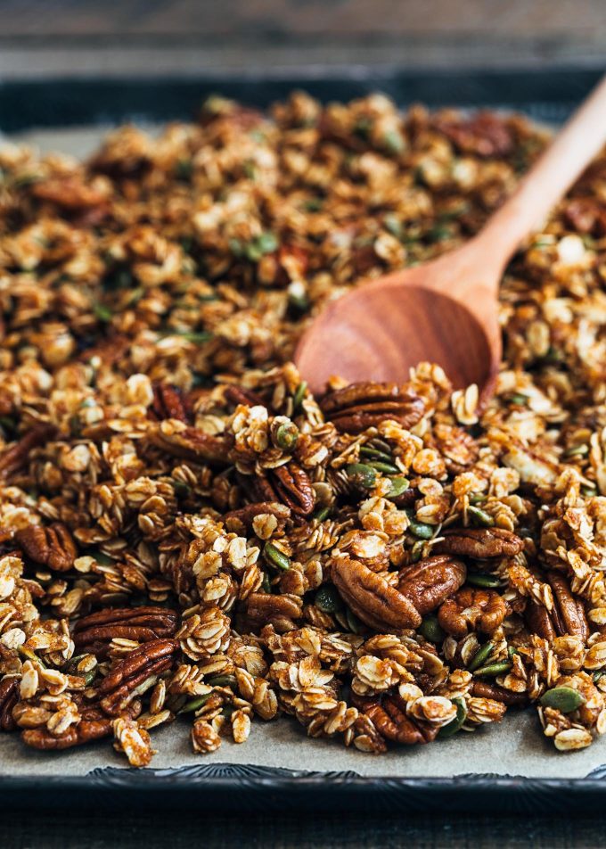 unbaked pumpkin granola with pecans on a sheet pan