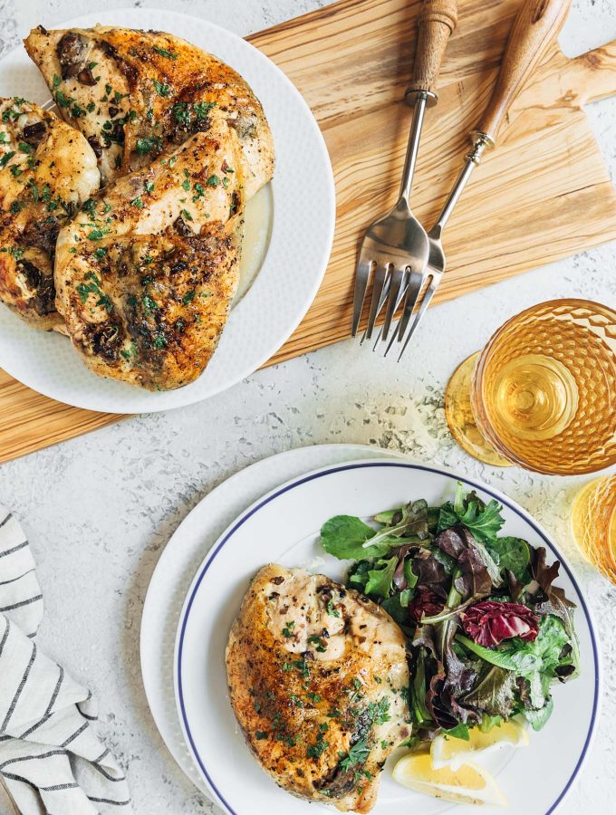 stuffed chicken breasts served on a platter and on a white plate