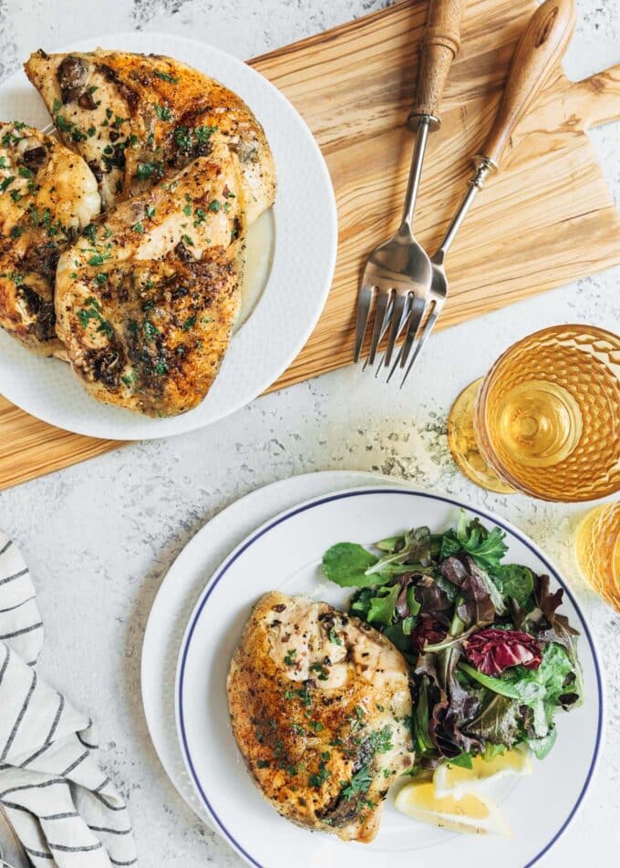 stuffed chicken breasts served on a platter and on a white plate