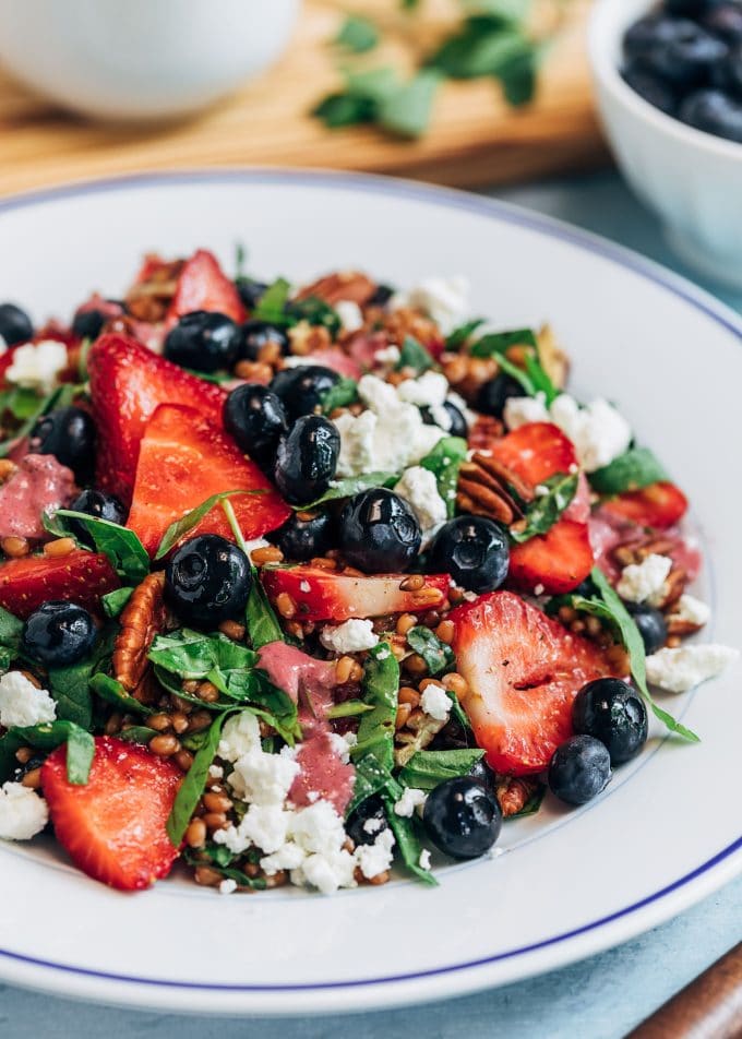 wheat berry salad on a white plate with berries and goat cheese {sponsored}