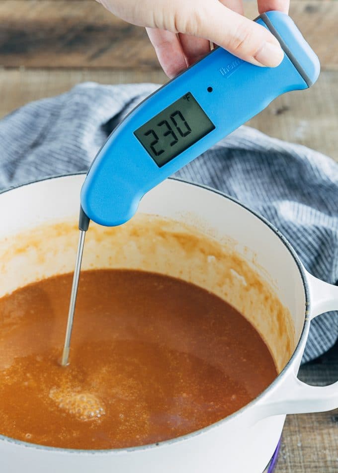 instant thermometer showing temperature of apple cider caramel