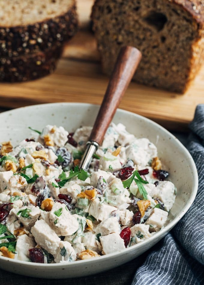 cranberry walnut chicken salad in a bowl with a spoon