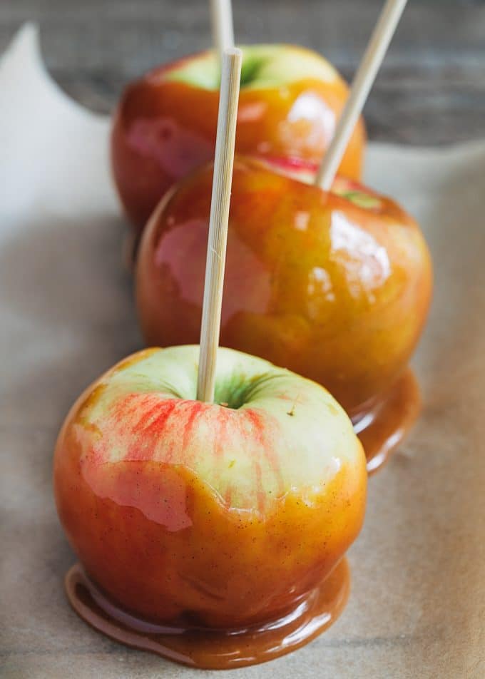 caramel dipped honeycrisp apples on parchment paper