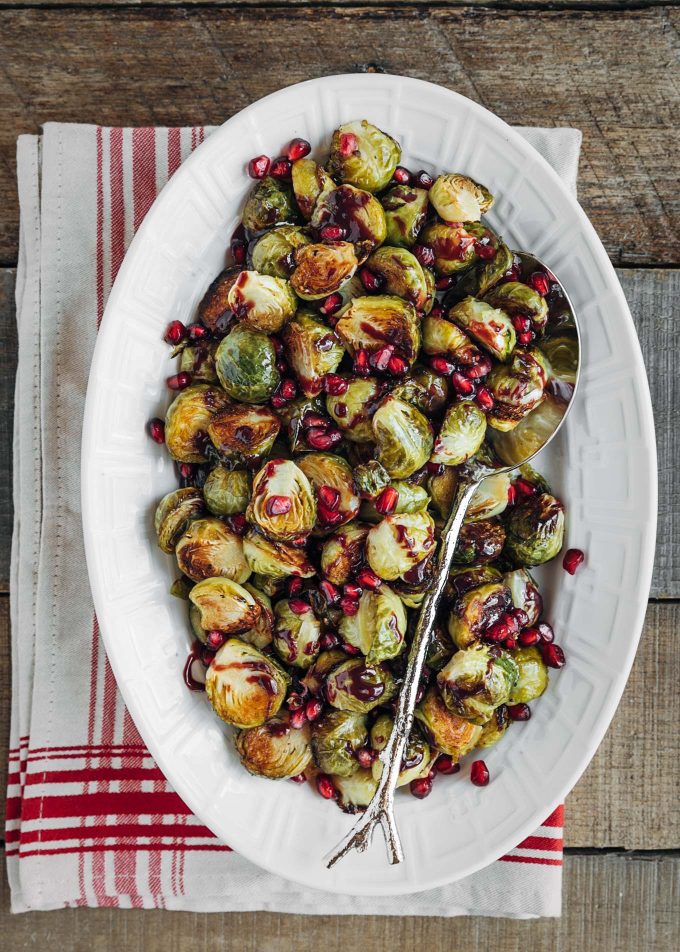 roasted brussels sprouts with pomegranate glaze in a serving dish