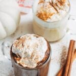 pumpkin hot chocolate in mugs with brown sugar whipped cream