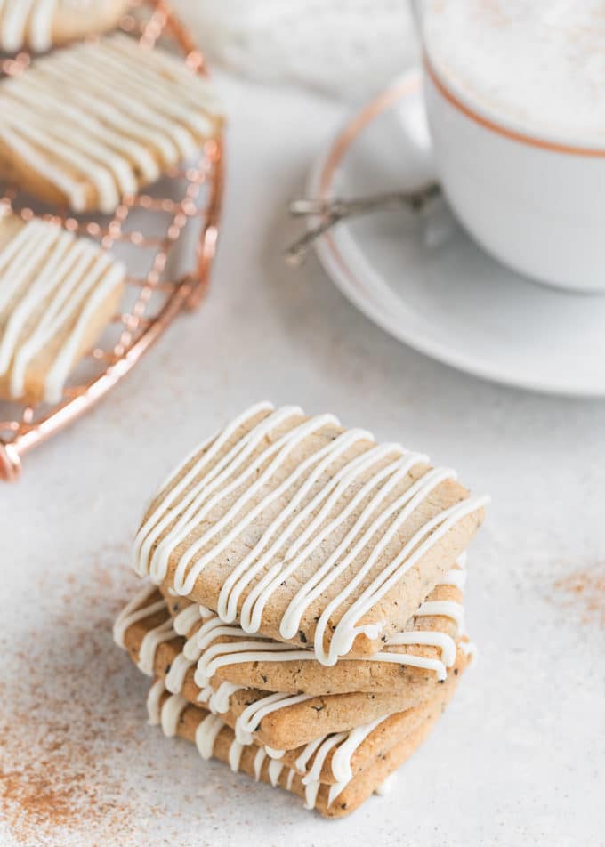 stack of chai shortbread cookies next to a chai tea latte