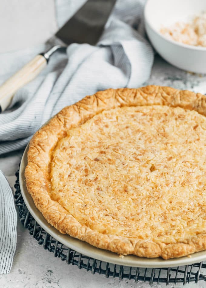 baked coconut custard pie on a cooling rack